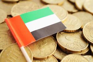 United Arab Emirates flag on coin and banknote money, finance trading investment business currency concept. photo