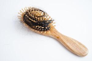 Asian woman have problem with long hair loss attach to comb brush. photo