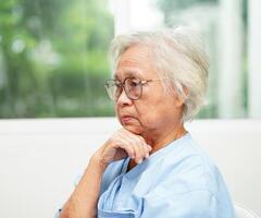 Asian senior woman wearing eyeglasses or vision glasses at home care service. photo