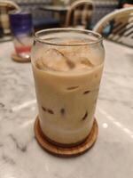 Iced Caffee Latte on Marble Table with Elegant Cafe Ambiance photo