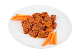 Boneless chicken wings with buffalo sauce and carrots photo