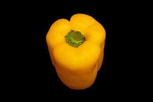 Yellow pepper in black background photo