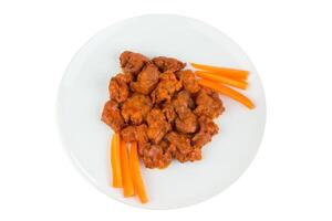 Boneless chicken wings with buffalo sauce and carrots photo