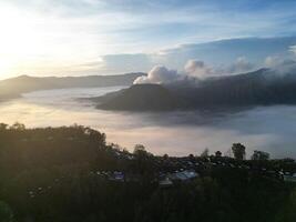 panoramic view of the sunrise on Mount Bromo with a sea of clouds in the morning photo
