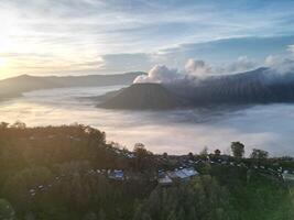 panoramic view of the sunrise on Mount Bromo with a sea of clouds in the morning photo