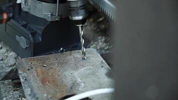 Close up of Drill bit Drilling into metal Pipe. Drilling a hole in the square steel pipe video