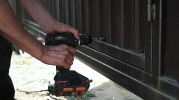 Close up of Drill bit Drilling into metal Pipe. Drilling a hole in the square steel pipe video