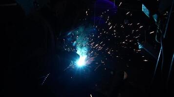 Welder Welds a metal pipe. Iron welding. Welding Sparks video