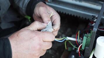 Electrician installs wiring using Connectors for connecting wires in automation and electronics equipment. Connection of electrical wires of electrical appliances video