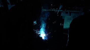 Welder Welds a metal pipe. Iron welding. Welding Sparks video