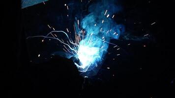 Welder Welds a metal pipe. Iron welding. Welding Sparks video