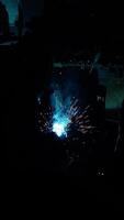 Welder Welds a metal pipe. Iron welding. Welding Sparks video