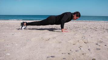 Boy Does Push Up Exercises In Outdoor Gym On The Beach Near The Sea video