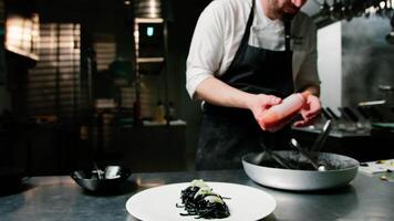 Chef Is Putting Tomato Sauce On Spaghetti With Squid Ink video