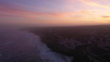 Azenhas do Mar Village in Portugal at Morning Twilight, Cliffs and Waves of Atlantic Ocean. Aerial View. Drone Moves Forward video