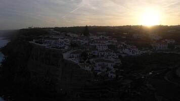 Azenhas do Mar Village in Portugal at Sunrise, Cliffs and Waves of Atlantic Ocean. Aerial View. Drone Moves Backwards and Upwards video