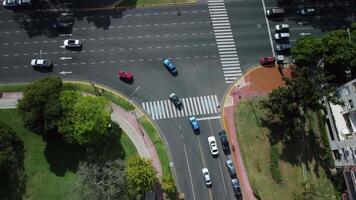 Busy Buenos Aires city street. Urban road, traffic intersection, crosswalk, cars, bus. Modern architecture, high buildings. Aerial view from drone above. Skyline, downtown landmark. video