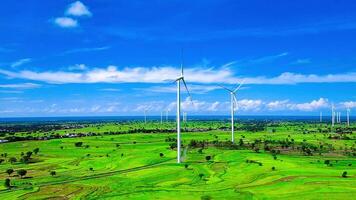 Aerial view of a wind turbine farm with rice paddies and a beautiful sky video