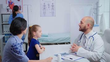 radiologue ayant bien nouvelles pour enfant après examiner radiographie. soins de santé praticien médecin spécialiste dans médicament fournir se soucier prestations de service consultation, radiographique traitement dans hôpital cabinet video