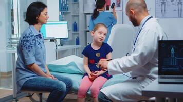 Pediatrician listening child symptoms trying to treat health problems. Healthcare practitioner, physician, specialist in medicine providing care services consultation diagnostic treatment in hospital. video