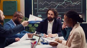 Time lapse of shareholders attend a meeting in a conference room, sharing insight on new development project and analyzing online statistics to ensure corporation success. Fast forward speed. video