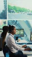 Vertical Indian call center operator gathers location and gps coordinates, monitoring traffic via surveillance camera system. Employee using CCTV real time footage to collect data. Camera B. video