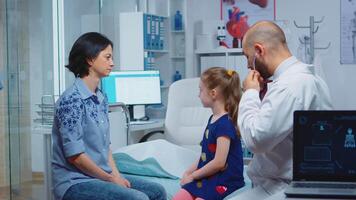 Physician examining lungs using stethoscope, listening child breath. Healthcare practitioner doctor specialist in medicine providing health care services consultation examination treatment in hospital video