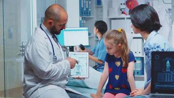 Doctor showing skeleton graphics on tablet during consultation. Healthcare practitioner physician specialist in medicine providing health care service radiographic treatment examination in hospital video