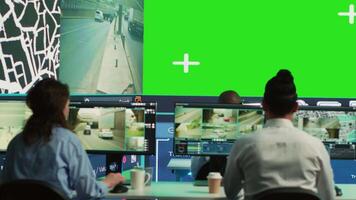 Group of employees monitoring delivery trucks routes with an isolated screen, working with satellite map and radar. Diverse people look at greenscreen display, order tracking. Camera A. video