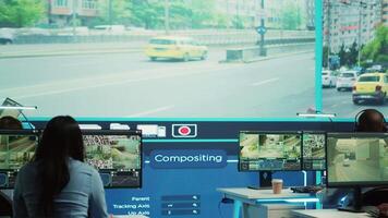 Indian manager supervising his employees team in observation room, people monitoring traffic through satellite system CCTV cameras. Diverse group working on surveillance tracking. Camera A. video