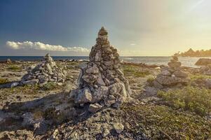 Stacks of zen rocks in Puerto Aventuras's Coast photo
