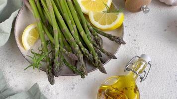 Preparing Fresh Asparagus With Lemon And Olive Oil On A Kitchen Counter video