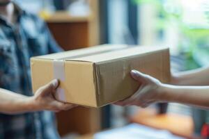 Close up of hands handing over cardboard box to delivery man photo