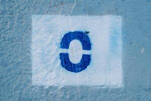 Number zero painted on a blue wall in a rectangle photo