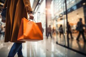 un mujer es caminando abajo un calle con un grande compras bolso foto