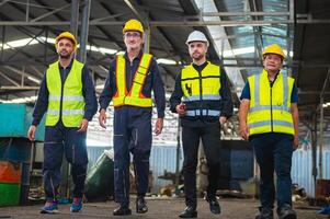 Four men in safety vests walk through a building photo