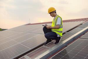 man in a yellow vest is working on a solar panel photo