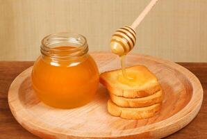 Pot of honey and rusks photo