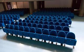 Rows of ble color theatre chairs photo