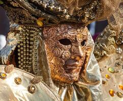 Golden mask with decorations and carvings, Venezia. photo