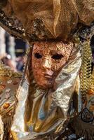 Golden mask with decorations and carvings, Venezia. photo