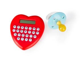 Calculator heart shaped and pacifier. photo