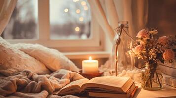 Cozy bedroom ambiance with a burning candle, open book, and fresh roses in a glass vase, emitting a warm, inviting glow. photo