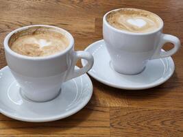 Coffee in white cups. Two white cups with coffee photo