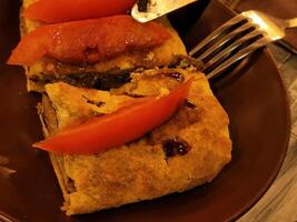 Casserole with mushrooms and tomatoes. Culinary pastries with tomatoes photo