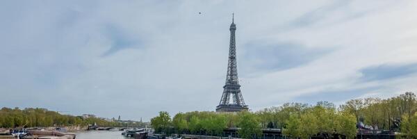 Scenic view of the Eiffel Tower from the Seines riverbank in Paris, France, capturing the essence of spring and tourism on April 14th, 2024 photo