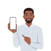 Young black man holding smartphone screen and pointing it. vector