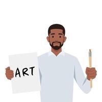 Young man holding paper with art written on it and holding paint brushes ready to paint. vector