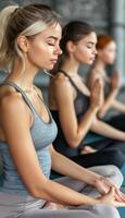 Group of young adults in a small gathering practicing yoga collectively at the gym photo