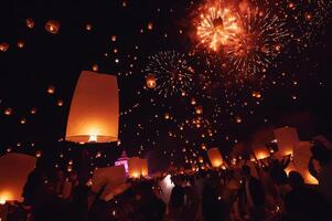 Chiang Mai - Thailand November 27, 2023. Tourists happily celebrate releasing lanterns at the Loi Krathong Yi Peng Lantern Festival according to Thai cultural traditions. photo